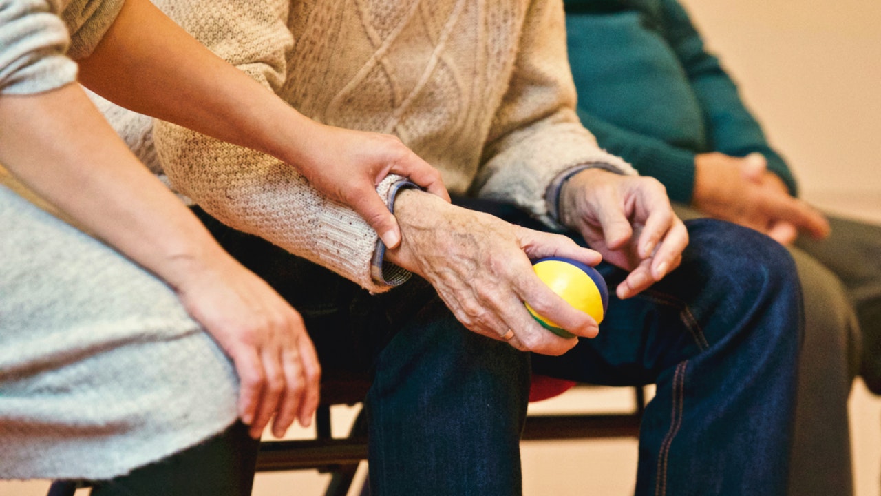 Elderly holding a ball