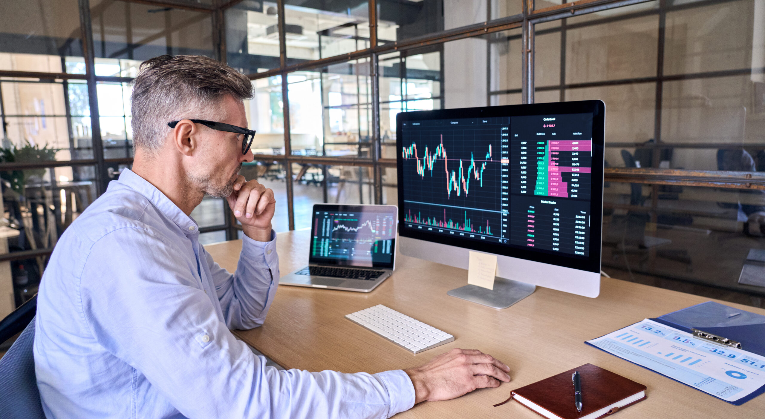 Busy crypto trader using computer analyzing digital stock market trading graph.