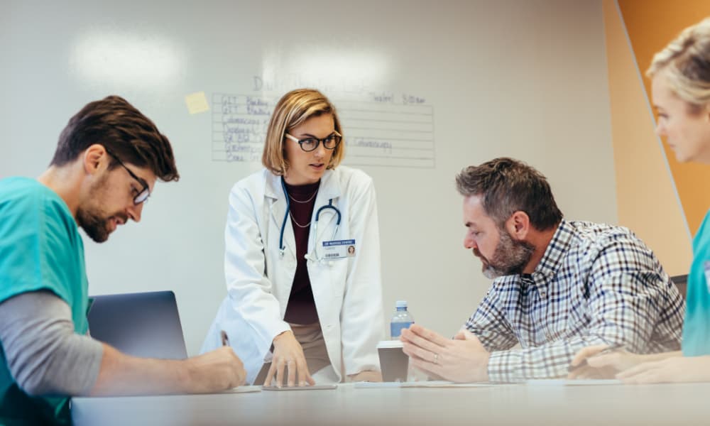 A lead doctor consults with her staff