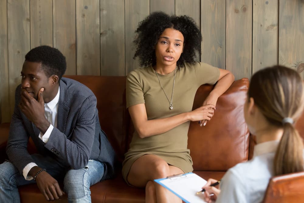 A frustrated couple considering divorce talks with a therapist.
