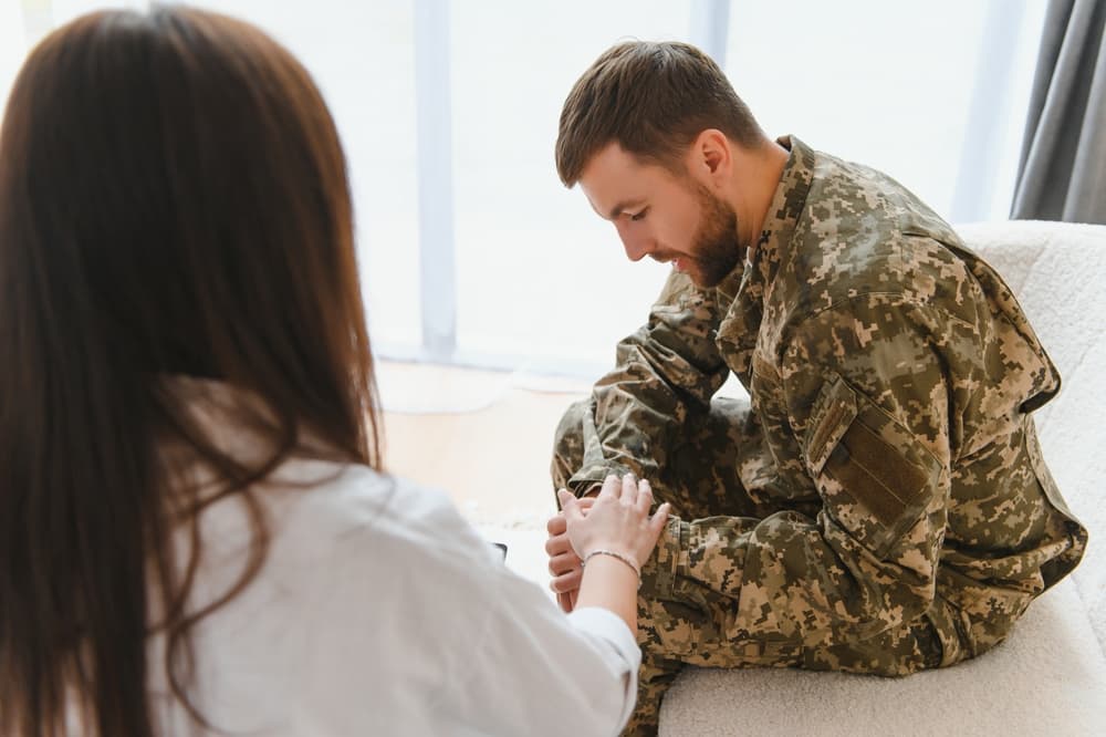 A marriage and family counselor works with a veteran suffering from PTSD.