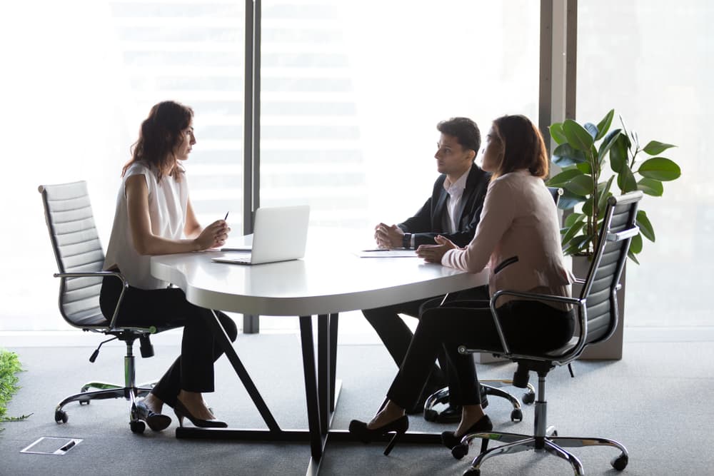 A mediator works with two of her clients in a dispute resolution