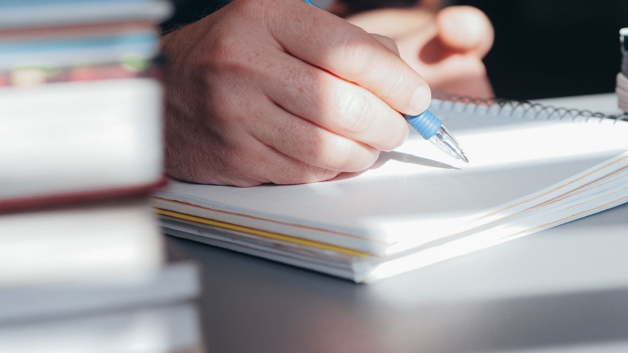 A hospital administrator sitting at an office desk working on administrative tasks